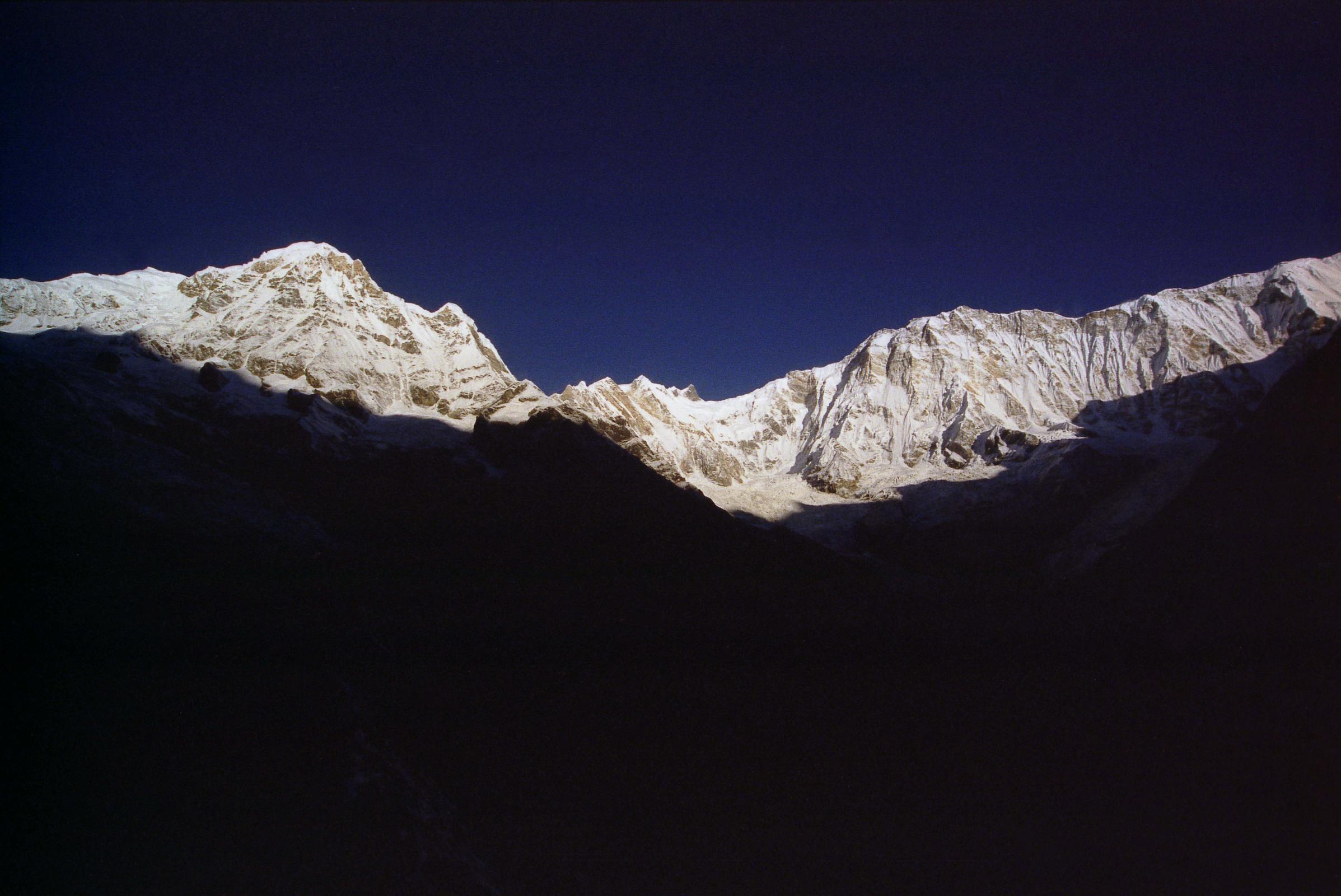 307 Annapurna South, Fang, Annapurna Main, Central, East Summits After Sunrise From Annapurna Sanctuary Base Camp I watched the rising sun illuminate more and more of the mountains for over an hour from Annapurna Sanctuary Base Camp. Here is a view from Annapurna South to Fang to Annapurna Main (8091m), Central (8051m), and East (8026m) summits and the 7.5km long ridge to Roc Noir (7485m).